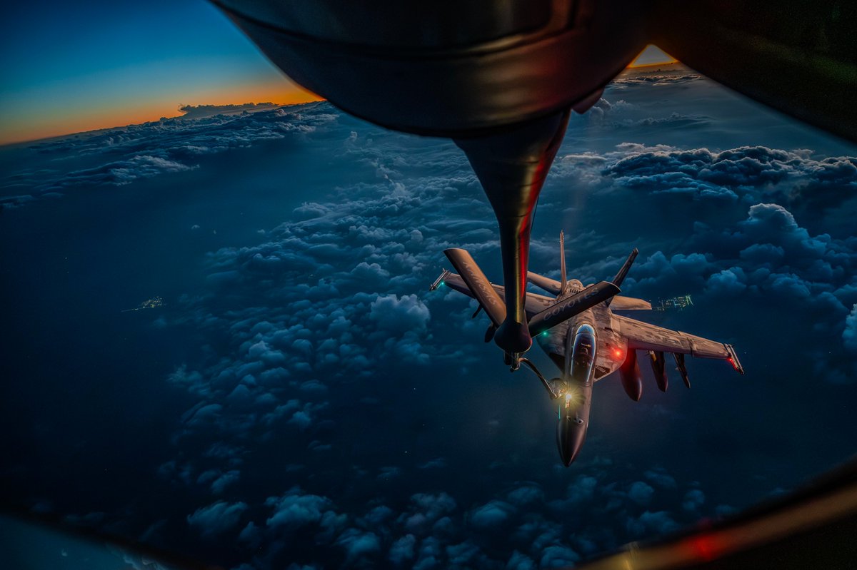 A U.S. Air Force KC-135 Stratotanker refuels a U.S. Navy F/A-18F Super Hornet over the middle east during Operation Epic Fury.