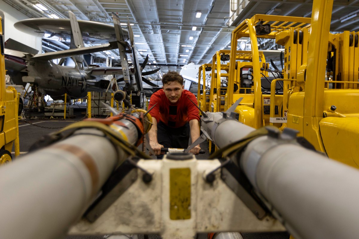 Service members aboard USS Abraham Lincoln (CVN 72) work around the clock to keep sea-based fighter jets equipped for combat during Operation Epic Fury.