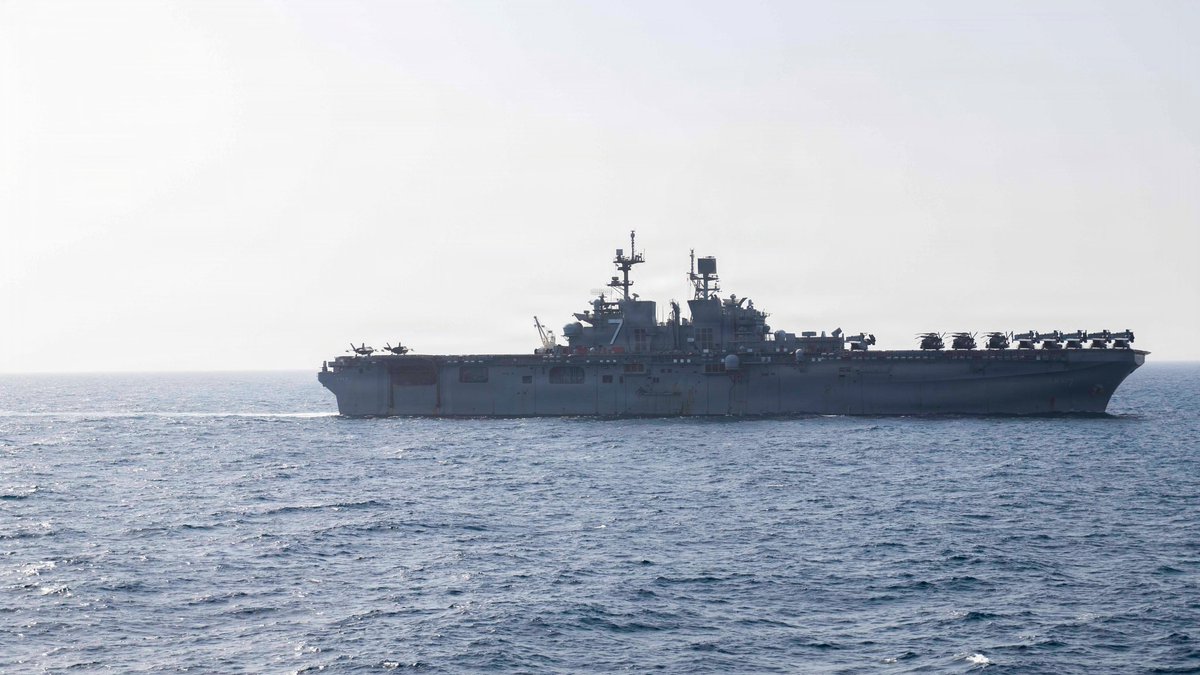 USS Tripoli (LHA 7) transits the Arabian Sea as the amphibious assault ship supports the ongoing U.S. blockade against Iran. U.S. forces have redirected 129 commercial vessels and disabled 6 to ensure compliance.