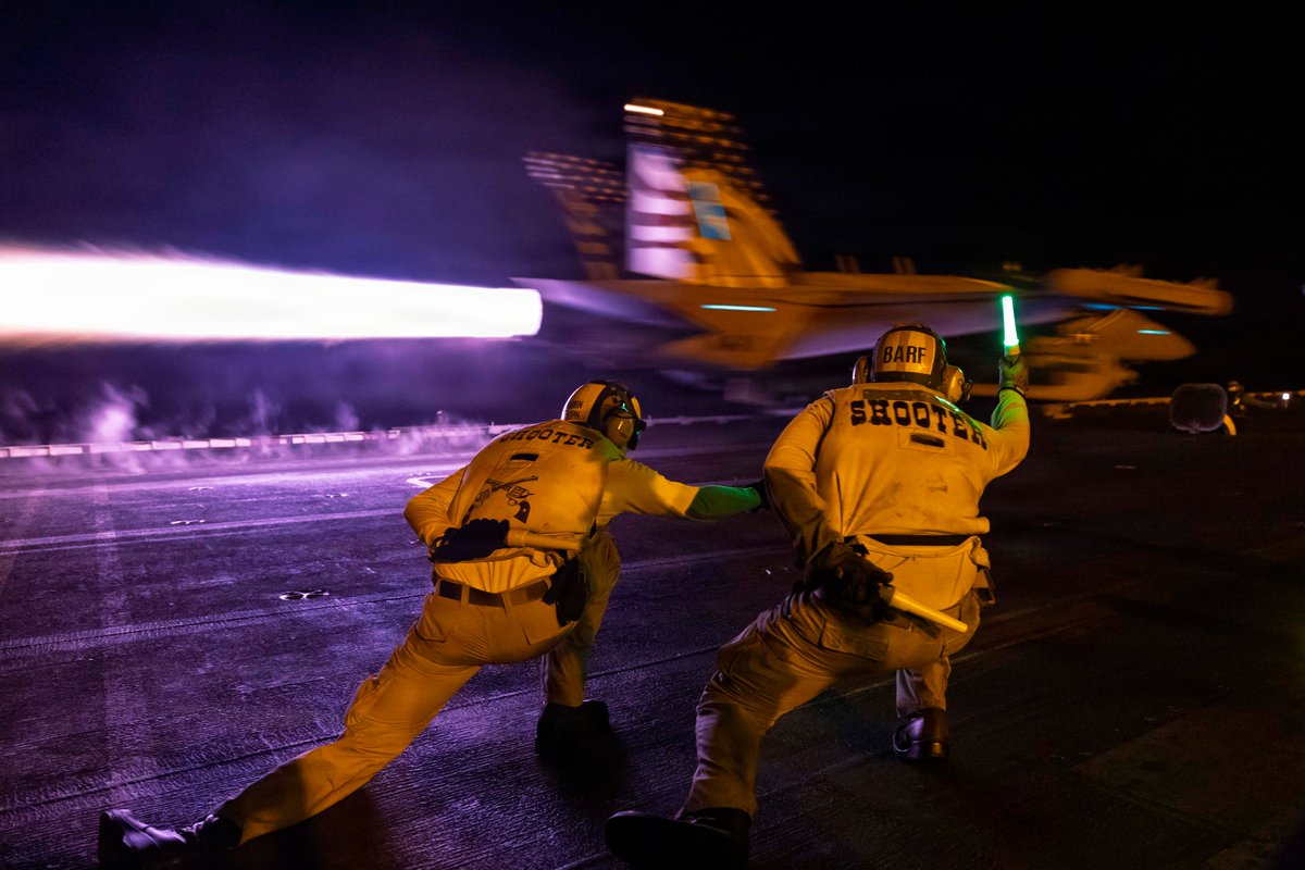 An E/A-18G aircraft launches from the flight deck of USS George H.W. Bush (CVN 77) during night flight operations while the ship supports enforcement of the U.S. blockade against Iran in the Arabian Sea. As of Sept. 7, CENTCOM forces have redirected 94 commercial vessels,