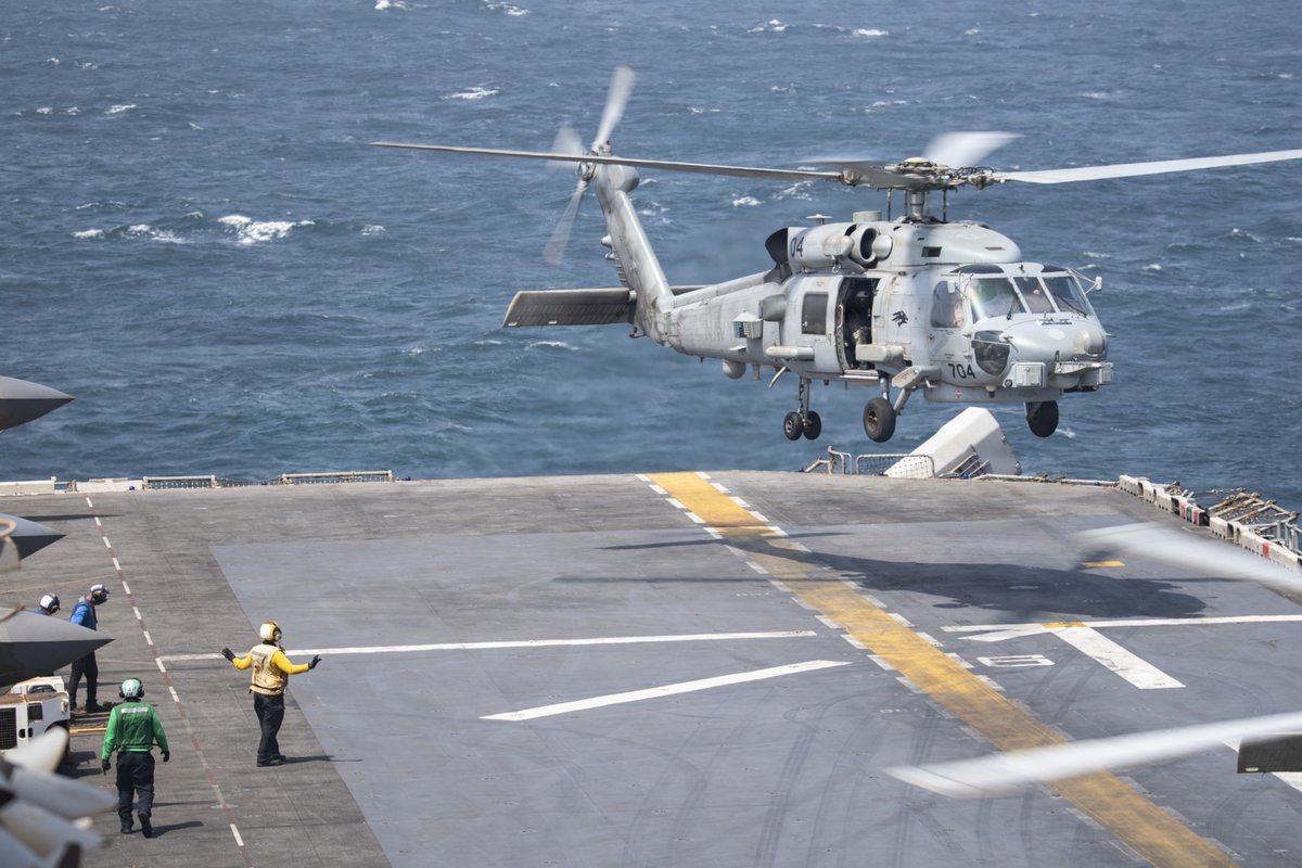 A U.S. Navy MH-60R Sea Hawk helicopter prepares to land on the flight deck aboard USS Boxer (LHD 4). Boxer is the flagship for the Boxer Amphibious Ready Group / 11th Marine Expeditionary Unit, which continues to enforce the U.S. blockade against Iran. As of Sept. 11, U.S. forces